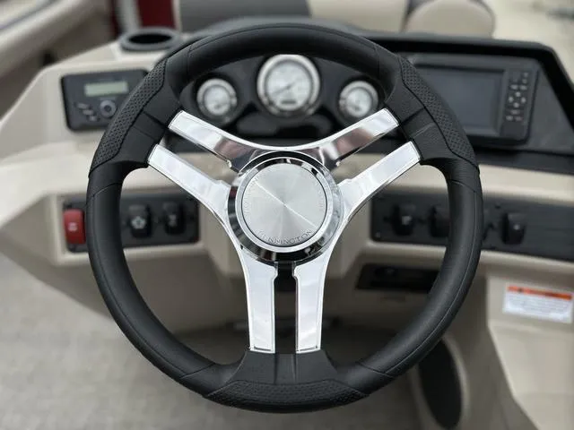 Slide: The Image of Steering wheel of 2024 Bennington 22 SSR Tri-Toon Pontoon with dashboard controls. - 33