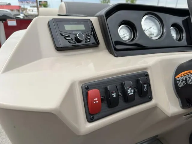 Slide: The Image of 2024 Bennington 22 SSR Tri-Toon Pontoon dashboard with controls and gauges. - 38