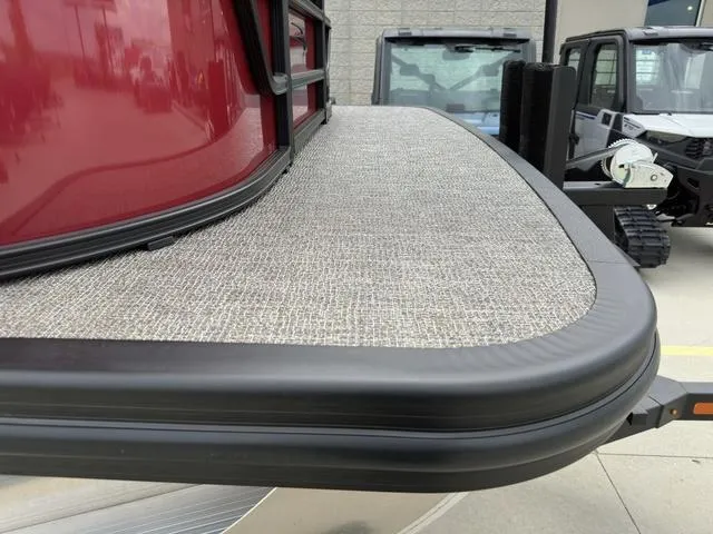 Slide: The Image of 2024 Bennington 22 SSR Tri-Toon Pontoon, red exterior, textured deck, outdoor display. - 4