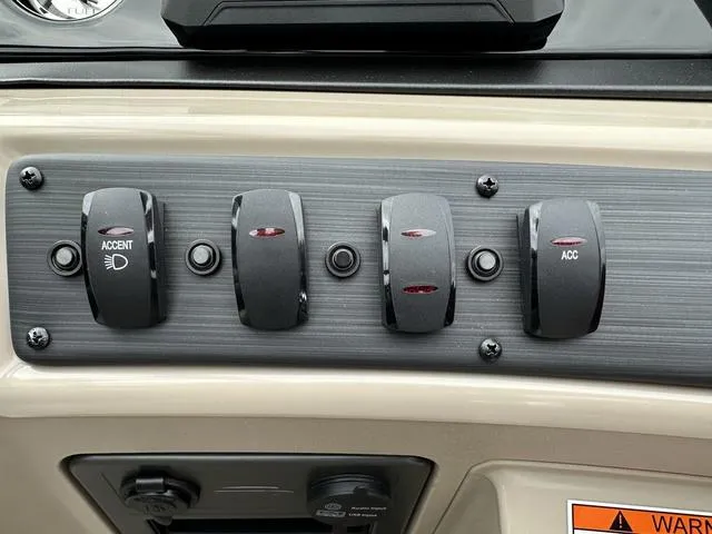 Slide: The Image of Control panel of 2024 Bennington 22 SSR Tri-Toon Pontoon with switches and warning label. - 42