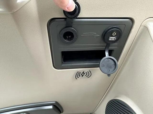 Slide: The Image of 2024 Bennington 22 SSR Tri-Toon Pontoon USB and power ports with wireless charging pad. - 45