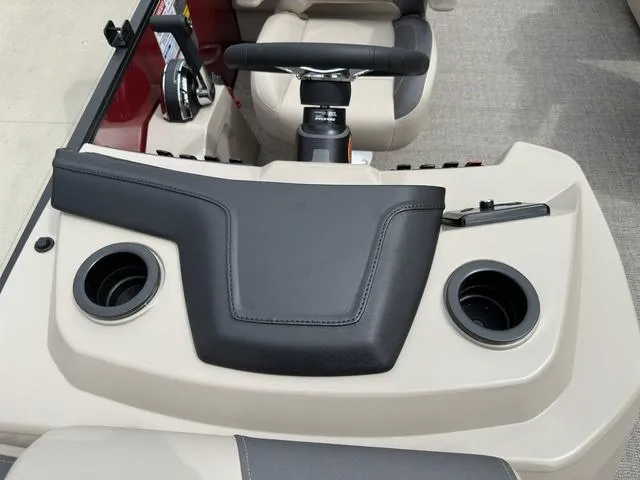 Slide: The Image of 2024 Bennington 22 SSR Tri-Toon Pontoon dashboard with steering wheel and cup holders. - 47