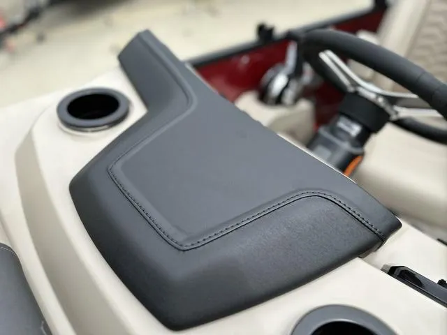 Slide: The Image of 2024 Bennington 22 SSR Tri-Toon Pontoon dashboard with steering wheel and cup holders. - 48