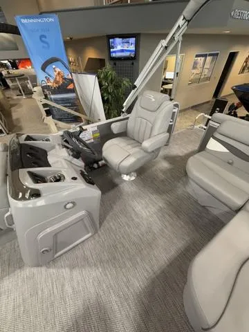 Slide: The Image of 2024 Bennington 208SLJ boat interior with plush seating and modern controls. - 10