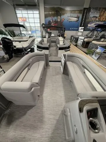 Slide: The Image of 2024 Bennington 208SLJ pontoon boat interior with spacious seating in a showroom. - 11