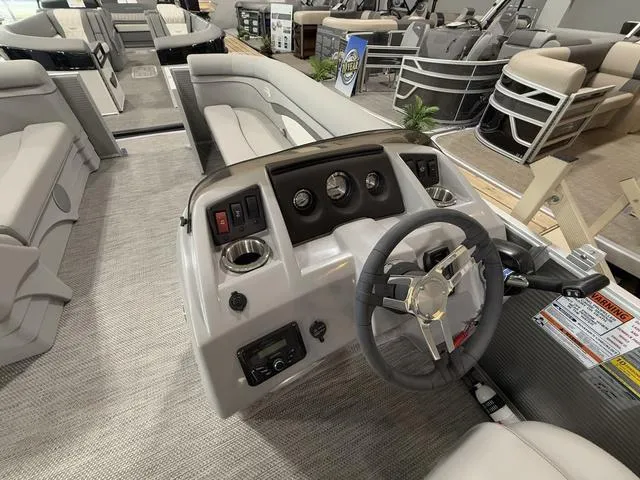 Slide: The Image of 2024 Bennington 208SLJ boat interior with steering wheel and control panel. - 12