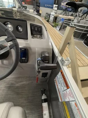 Slide: The Image of 2024 Bennington 208SLJ boat dashboard with controls and safety features. - 18