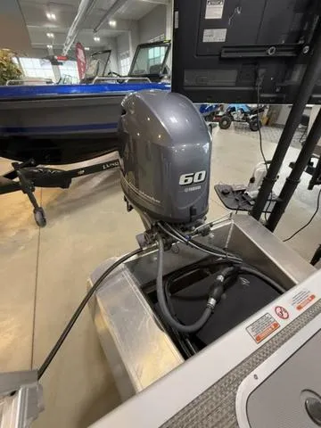 Slide: The Image of 2024 Bennington 208SLJ boat with a 60 horsepower outboard motor in a showroom. - 20