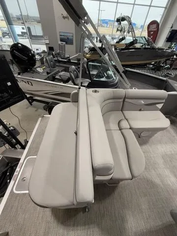 Slide: The Image of 2024 Bennington 208SLJ boat interior with plush seating in a showroom. - 22