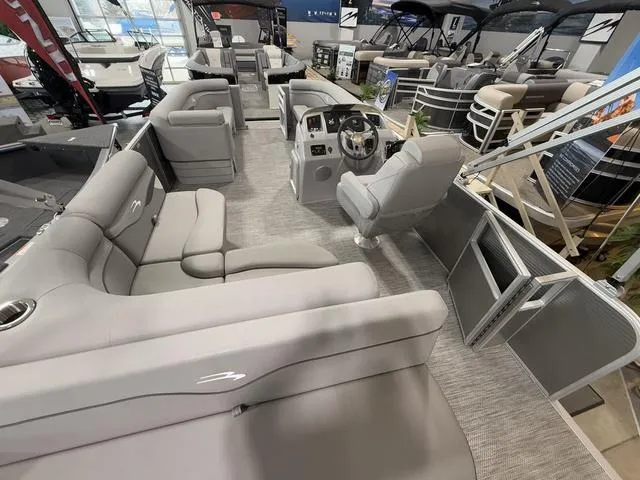 Slide: The Image of 2024 Bennington 208SLJ pontoon boat interior with plush seating and modern helm. - 23