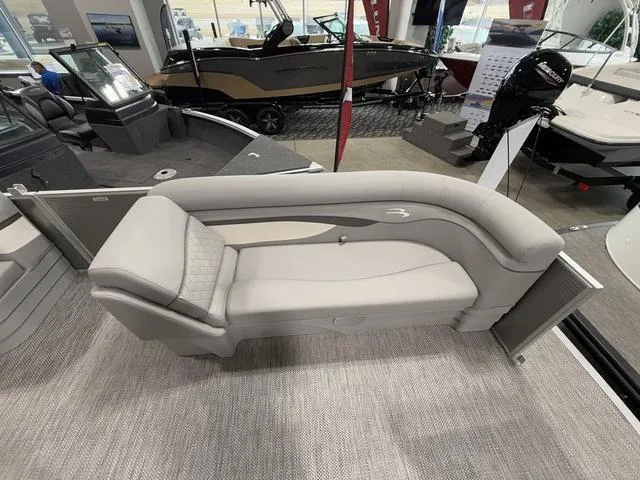 Slide: The Image of 2024 Bennington 208SLJ boat interior with sleek seating design in showroom. - 5
