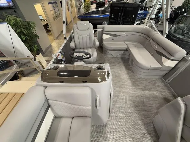 Slide: The Image of 2024 Bennington 208SLJ pontoon boat interior with plush seating and modern helm. - 7