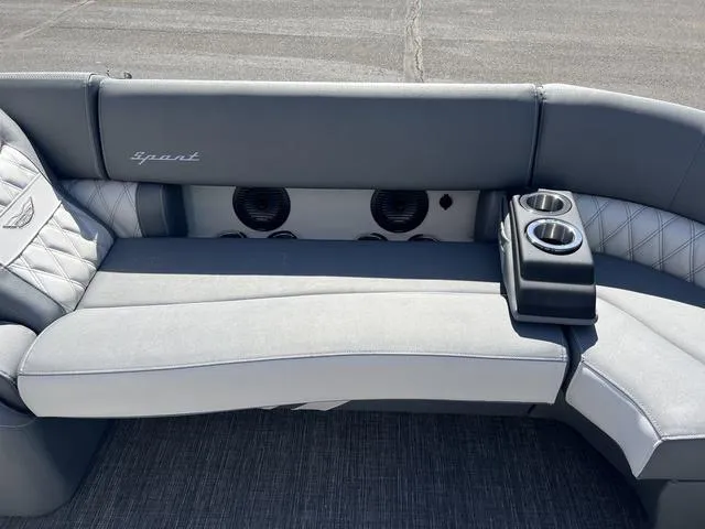 Slide: The Image of 2024 Bennington 25RX Swingback ESP Tri-Toon Pontoon interior with gray seating and cup holders. - 13