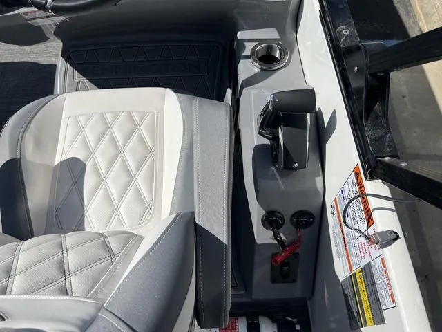 Slide: The Image of 2024 Bennington 25RX Swingback ESP Tri-Toon Pontoon interior with diamond-stitched seat and control panel. - 16