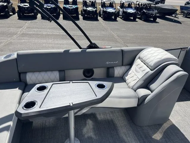 Slide: The Image of 2024 Bennington 25RX Swingback ESP Tri-Toon Pontoon interior with gray seating and table. - 17