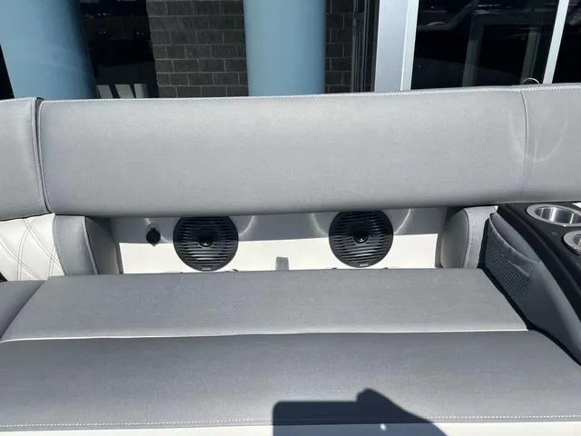 Slide: The Image of 2024 Bennington 25RX Swingback ESP Tri-Toon Pontoon with gray seating and built-in speakers. - 18