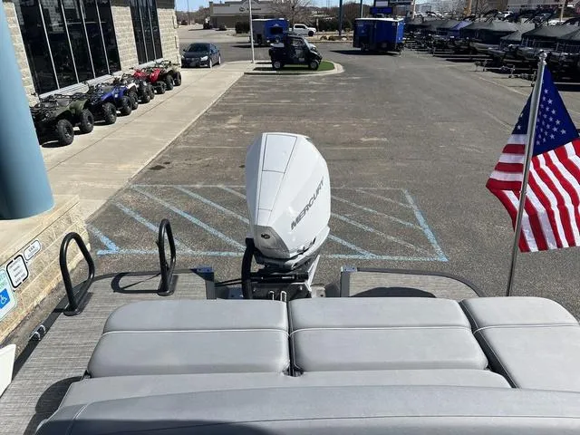 Slide: The Image of 2024 Bennington 25RX Swingback ESP Tri-Toon Pontoon with Mercury engine and American flag. - 20