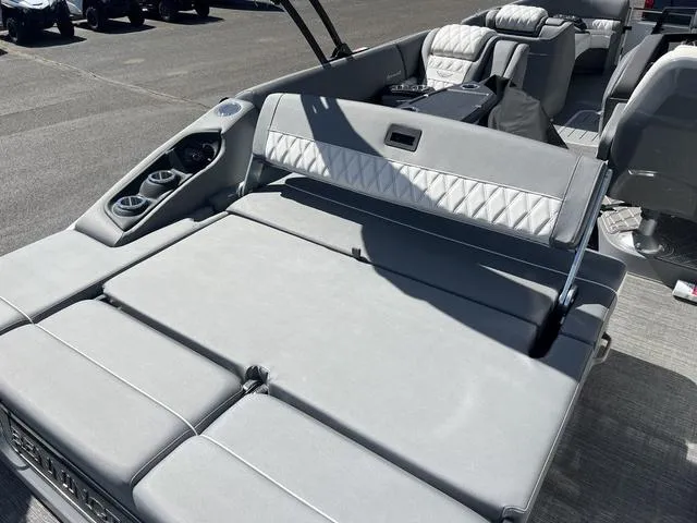Slide: The Image of 2024 Bennington 25RX Swingback ESP Tri-Toon Pontoon with luxurious gray seating and cup holders. - 21