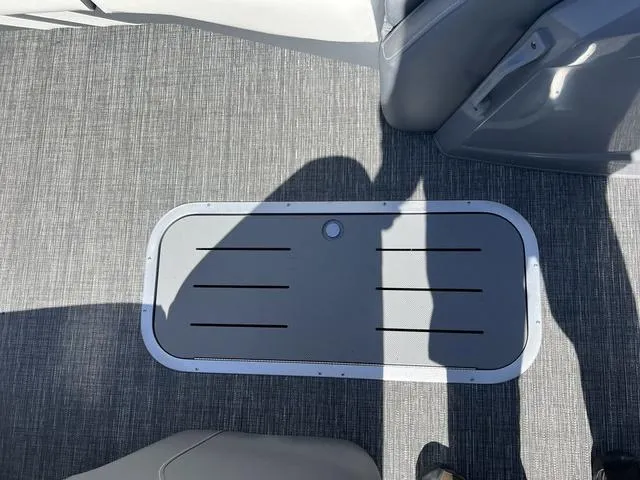 Slide: The Image of 2024 Bennington 25RX Swingback ESP Tri-Toon Pontoon floor detail with storage hatch. - 26
