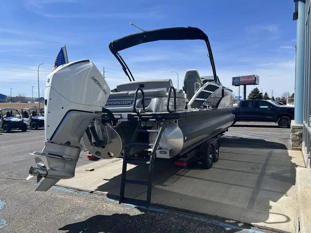 Slide: The Image of 2024 Bennington 25RX Swingback ESP Tri-Toon Pontoon with Mercury outboard engine, parked outdoors. - 4
