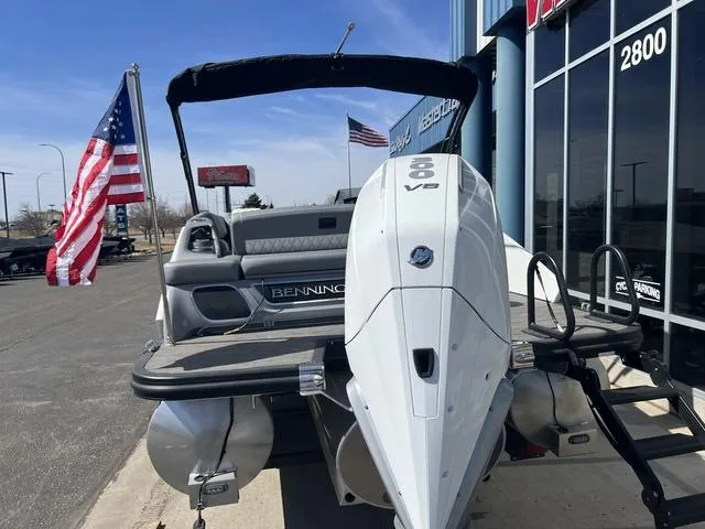 Slide: The Image of 2024 Bennington 25RX Swingback ESP Tri-Toon Pontoon with American flags in the background. - 5