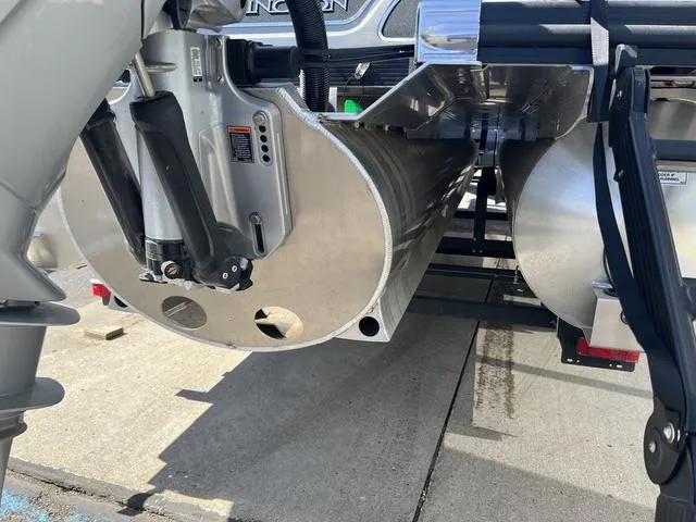 Slide: The Image of 2024 Bennington 25RX Swingback ESP Tri-Toon Pontoon rear view, showcasing engine and pontoons. - 6