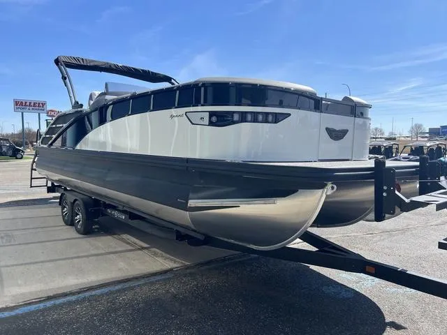 Slide: The Image of 2024 Bennington 25RX Swingback ESP Tri-Toon Pontoon on trailer, parked outdoors under clear sky. - 8