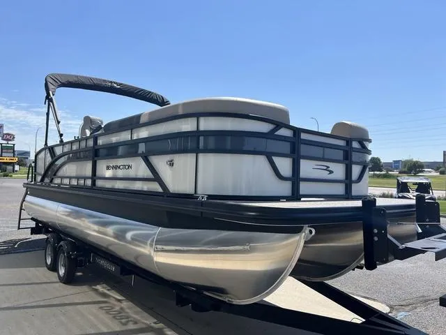 Slide: The Image of 2024 Bennington 22SSB-SPS pontoon boat on trailer, sunny day, outdoor setting. - 10