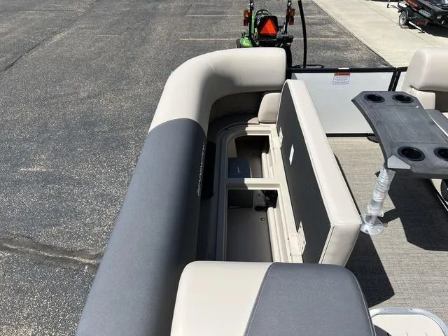 Slide: The Image of 2024 Bennington 22SSB-SPS pontoon boat interior with seating and storage compartments. - 13