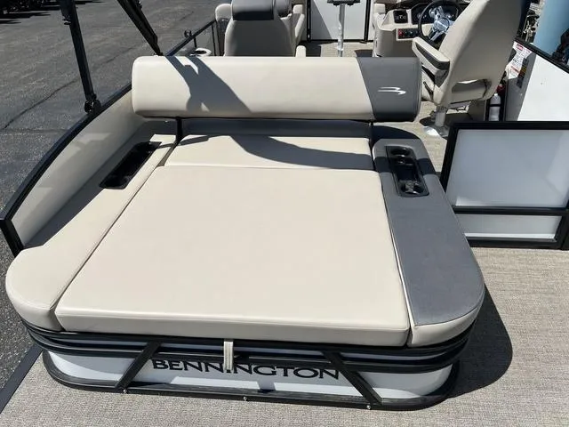 Slide: The Image of 2024 Bennington 22SSB-SPS pontoon boat with beige seating and sleek design. - 22