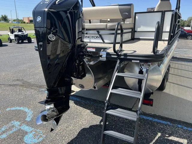 Slide: The Image of 2024 Bennington 22SSB-SPS pontoon boat with outboard motor and ladder in parking lot. - 6