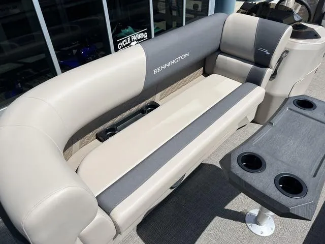 Slide: The Image of 2024 Bennington 22SSB-SPS pontoon boat seating with cup holders, beige and gray upholstery. - 8