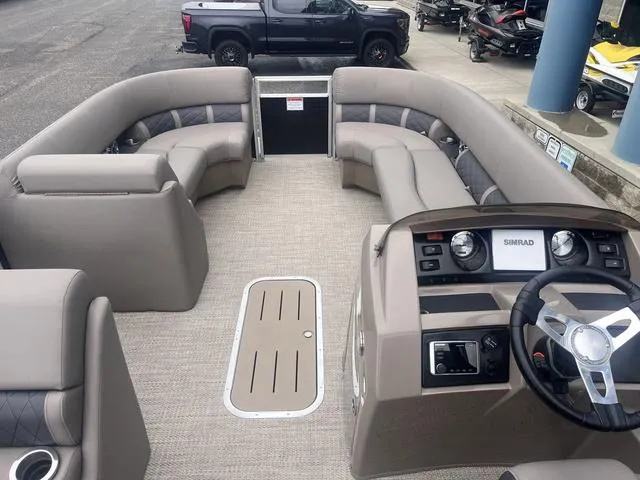 Slide: The Image of 2019 Bennington 23 SSBXP pontoon boat interior with plush seating and modern dashboard. - 10