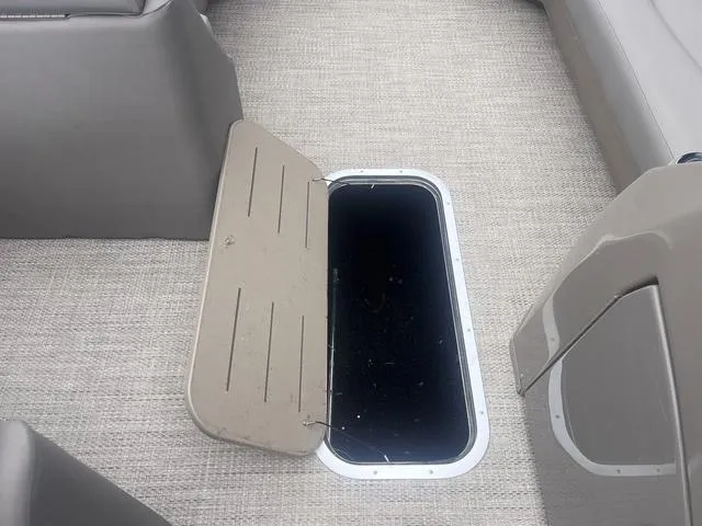 Slide: The Image of Open storage compartment on 2019 Bennington 23 SSBXP boat with beige interior. - 11