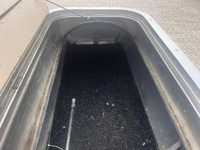 Slide: The Image of Storage compartment of a 2019 Bennington 23 SSBXP boat, featuring a black interior. - 12