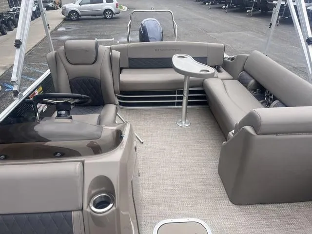 Slide: The Image of 2019 Bennington 23 SSBXP pontoon boat interior with seating and table, parked on a lot. - 16