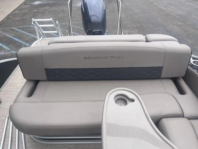 Slide: The Image of 2019 Bennington 23 SSBXP boat with beige seating and visible outboard motor. - 18