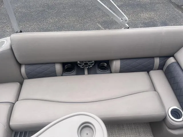 Slide: The Image of 2019 Bennington 23 SSBXP boat interior with gray cushioned seating and cup holders. - 19