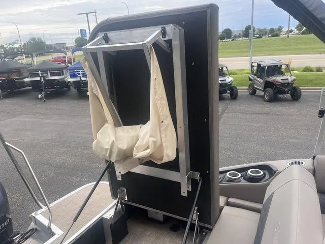 Slide: The Image of 2019 Bennington 23 SSBXP boat with a foldable changing room on deck. - 20