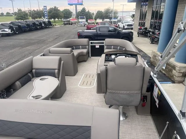 Slide: The Image of 2019 Bennington 23 SSBXP pontoon boat interior with plush seating and steering console. - 22