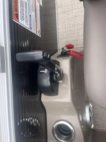 Slide: The Image of 2019 Bennington 23 SSBXP boat throttle control with safety lanyard and warning label. - 24