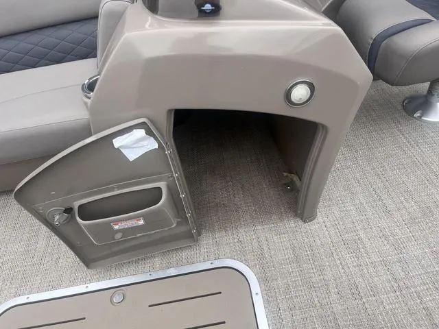 Slide: The Image of 2019 Bennington 23 SSBXP boat interior with open storage compartment and seating. - 29