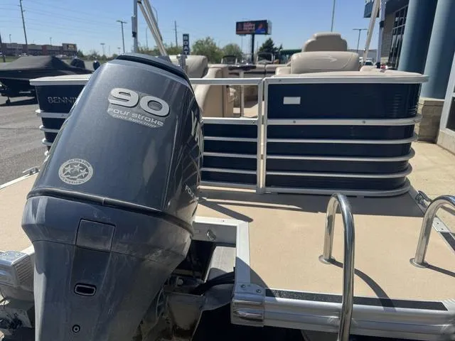 Slide: The Image of 2010 Bennington 2250RCW Pontoon with 90 horsepower outboard motor, docked in a marina. - 10
