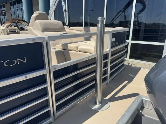 Slide: The Image of 2010 Bennington 2250RCW Pontoon boat with beige seating and sleek railing design. - 11