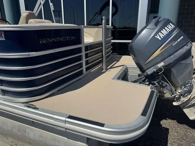 Slide: The Image of 2010 Bennington 2250RCW Pontoon with Yamaha outboard motor, docked near a building. - 12