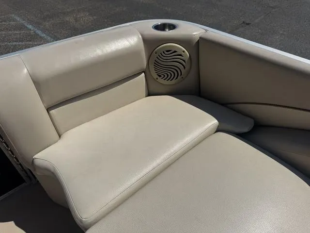 Slide: The Image of Beige seating area on a 2010 Bennington 2250RCW Pontoon boat with speaker and cup holder. - 16