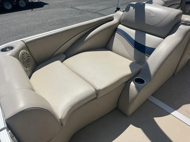 Slide: The Image of 2010 Bennington 2250RCW Pontoon boat interior with beige seating and cup holders. - 18