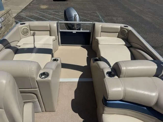 Slide: The Image of 2010 Bennington 2250RCW Pontoon boat interior with beige seating and cup holders. - 20