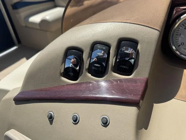Slide: The Image of Control panel of a 2010 Bennington 2250RCW Pontoon boat with switches and gauges. - 22