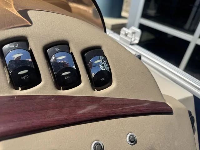 Slide: The Image of Control panel of a 2010 Bennington 2250RCW Pontoon with bilge, nav, and acc switches. - 24